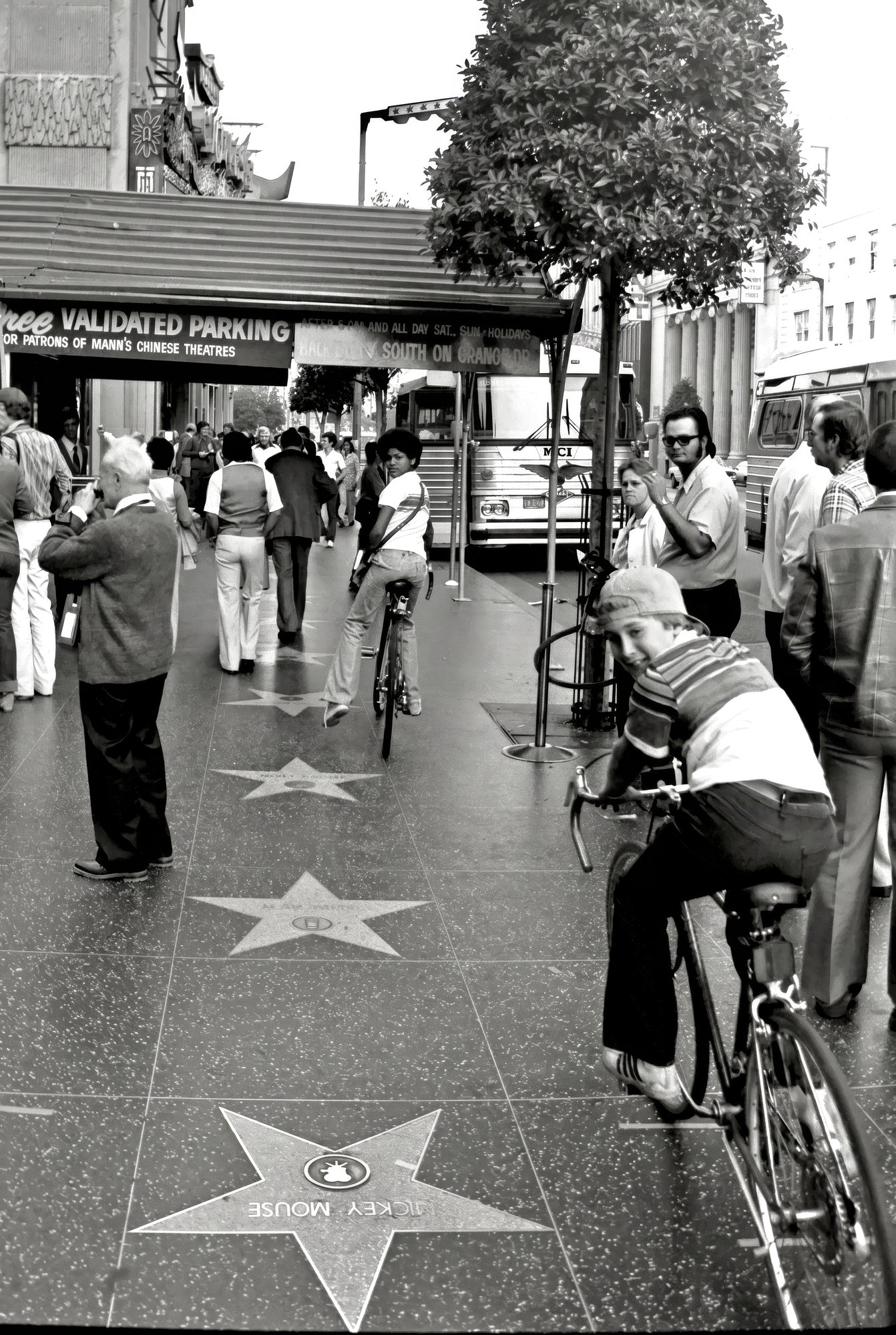 Boy on a bicycle near Mickey Mouse star, Hollywood Walk of Fame