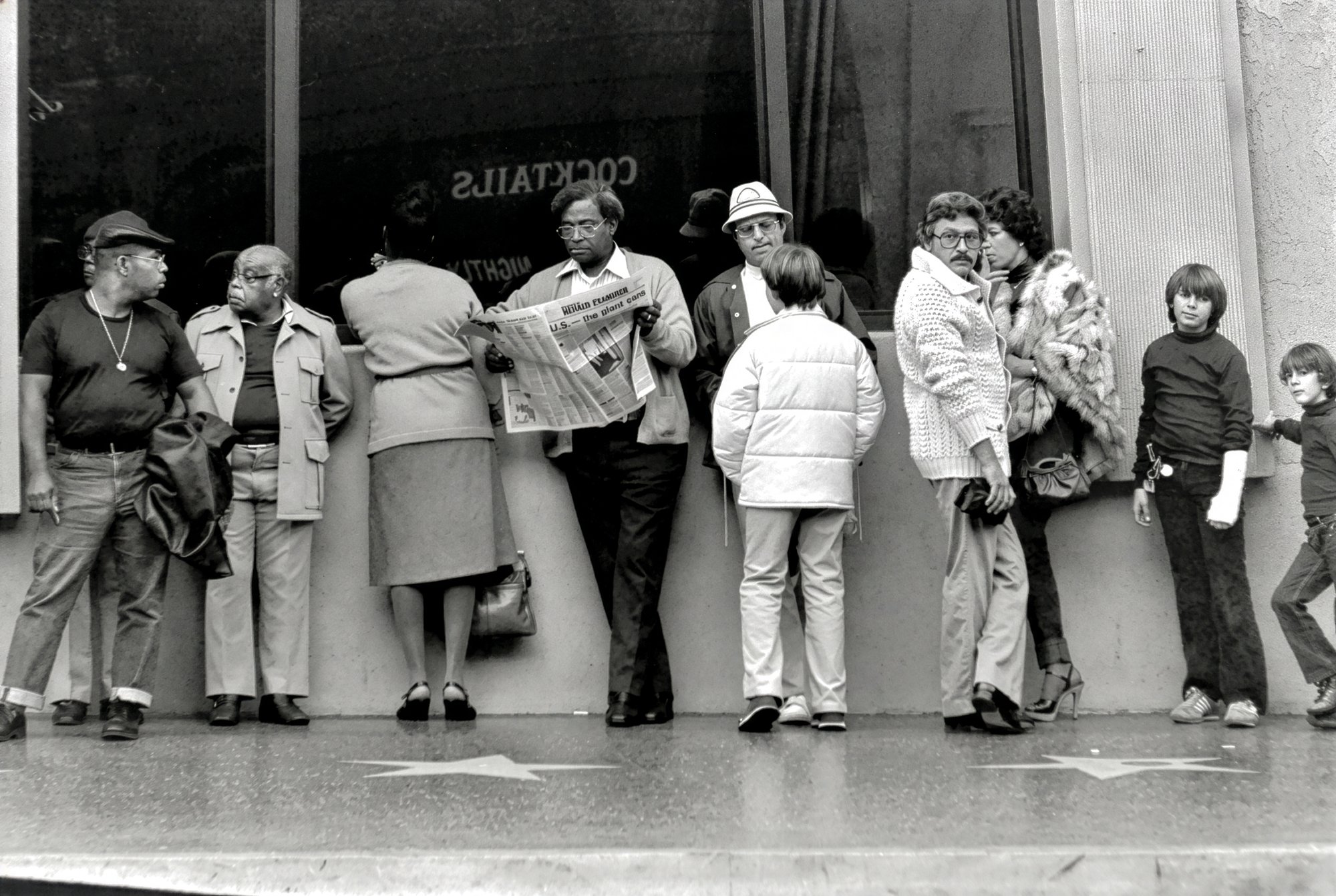 Bystanders along Hollywood Boulevard's Walk of Fame stars